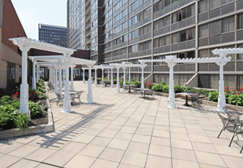 A patio with white pergolas and benches.